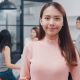 Portrait of successful beautiful executive businesswoman smart casual wear looking at camera and smiling, happy in modern office workplace. Young Asia lady standing relax in contemporary meeting room.